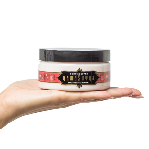 Body Soufflé Kissable Body Cream Strawberry Crème (7.5oz) in a hand, ideal for sensual massage and intimate care.